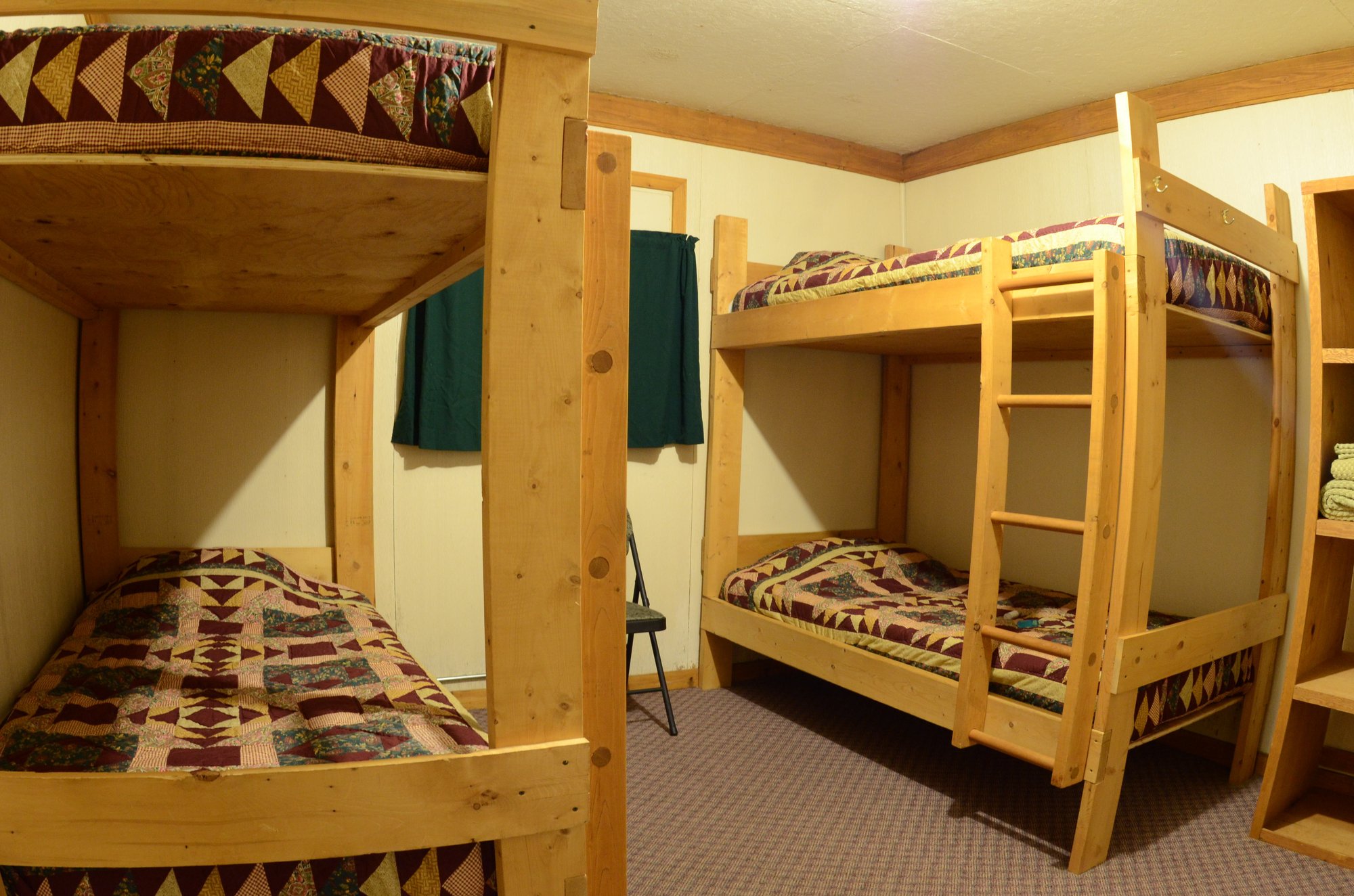 Lodge interior room showing two sets of wooden bunk beds